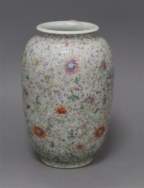 A Chinese famille rose ovoid vase, Qing dynasty, finely painted with flowers and scrolling foliage, H. 15cm, drilled hole to side of ba